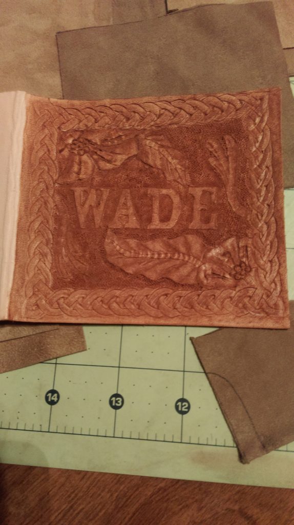Leather wallet with the name Wade surrounded with decorative rope and leaves
